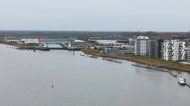 temse&rsquo;s riverside apartment buildings boelwerf crane scene luxury homes river scheldt panning shot temse belgium residential properties scenic view riverfront waterfront 