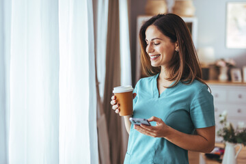 Smiling Professional Woman Enjoying Coffee Break With Mobile Phone