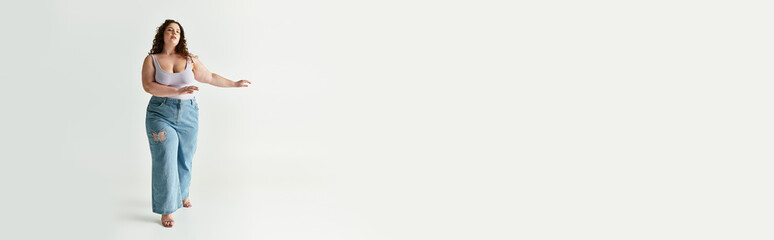 Charming young woman walks gracefully, embracing trendy fashion in a modern space.