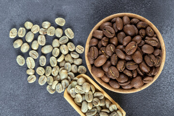 Green coffee with roasted coffee beans on gray background,closeup