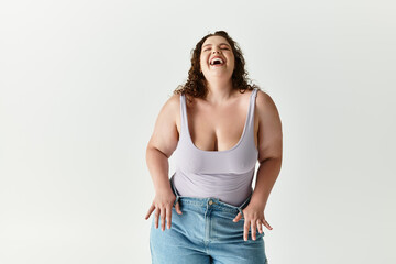 Bright smile radiates from the stylishly dressed woman enjoying a carefree moment indoors.