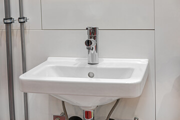 White Ceramic Rectangular Wash Basin With Silver Faucet in Small Bathroom