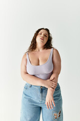 Confident woman showcases a fashionable outfit while striking a bold pose in a modern setting.