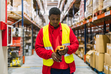 Warehouse worker scanning packages with barcode scanner