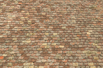 Texture of and old ruined roof, worn vintage roof tile surface as background