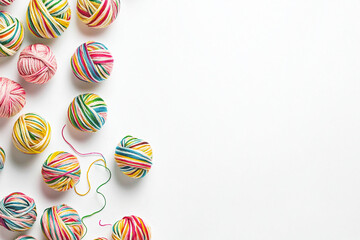Fototapeta premium Colorful yarn balls arranged on a bright surface for crafting