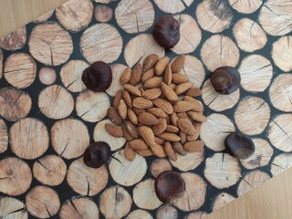 Yellow Lemons, almonds and shiny brown chestnuts on the table	
