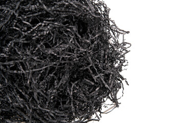 Black paper filler for gifts on a white background.View from above. Copy space.