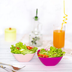 bowls of snacks and cookies on wooden white table. Rice, salads, juice, crackers.