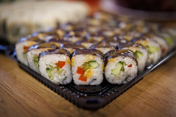 Fresh delicious sushi.Sushi on a black plastic backing.