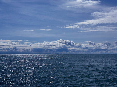Ocean blue shiny waters and beautiful sky clouds horizon