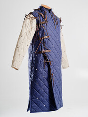 Historical fashion. Medieval knight cloth. Padded jacket gambeson.