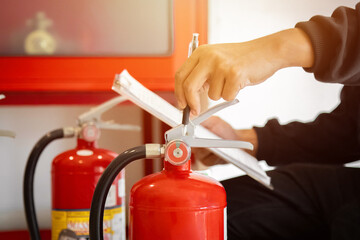 Naklejka premium Engineer check fire suppression system,check fire extinguisher tank in the fire control room for safety