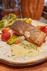 Grilled salmon with lemon cream sauce and mixed garden salad