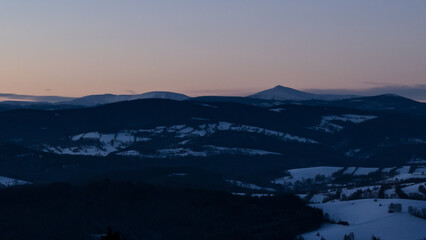Colorful sunset over the Czech countryside. View of the Krkonoše mountains from the Teplice-Adršpašská rocks.