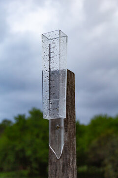 Close-up view of a rain gauge on a field pole