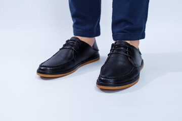 A man is wearing classic black shoes made of natural leather on lace, shoes for men under business style