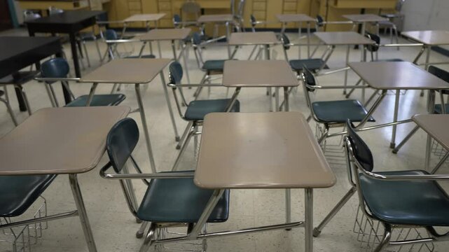 The empty classroom features neat rows of desks and chairs indicating a space prepared for learning and education awaiting students and teachers to begin their activities.