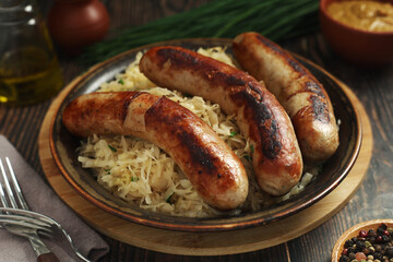 A bowl with Bratwurst and Sauerkraut as side dish - traditional German food	
