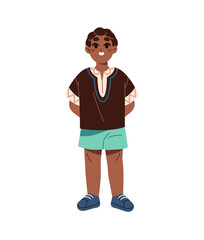 Fototapeta premium Cute little boy of African nationality stands. Funny black kid wearing traditional ethnic clothes. Happy child, schoolboy with smile on face. Flat isolated vector illustration on white background