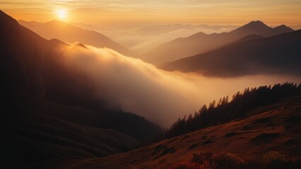 Obraz premium A serene sunrise scene with a mountain range shrouded in mist and fog filling the valley below