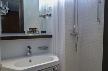 Old fashioned bathroom with sink and faucet inside dated cabin stateroom onboard historic classic...
