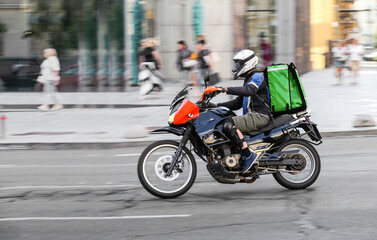 Abstract blurred image of a courier on a motorcycle