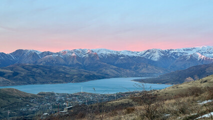 Snowy peaks mountains at the sunset