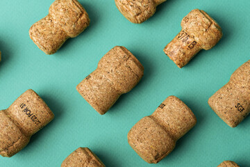Champagne corks arranged on a green background. Close-up highlighting the cork texture, symbolizing celebration, party, and wine culture.