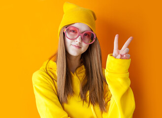 portrait of young pretty hipster woman wearing yellow hats and glasses.