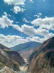 Fototapeta premium Views of Tibetan monastery, village, houses, green field and mountains along the road from Shangri La to Yading, Sichuan 