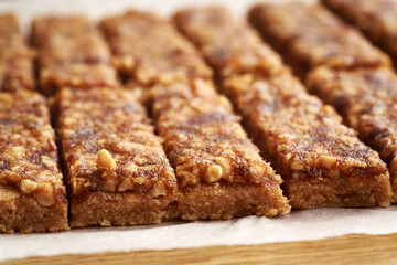 Close up of homemade no-bake healthy bars made of whey protein powder, peanut butter, maple syrup and dates