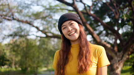 Naklejka premium Go green culture Gen z asia people young adult woman curly hair enjoy cheerful relax toothy smile happy face looking at camera nature tree public park save the earth eco friendly city life future hope
