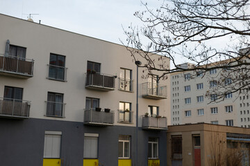 This is a multistorey building featuring an abundance of windows, along with several balconies offering unique views of the surroundings