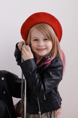 The girl in the red beret is smiling