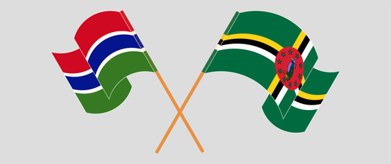 Crossed and waving flags of the Gambia and Dominica. Vector illustration