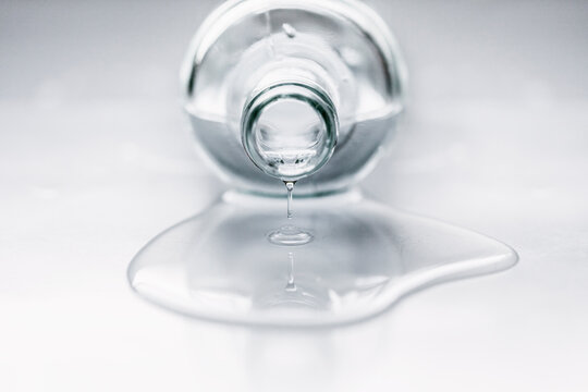 Close-up of a glass Bottle lying on table with water spilling out