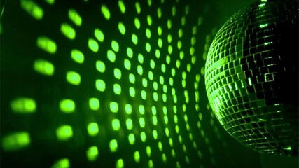 A shimmering disco ball reflects green lights, creating a vibrant pattern on the surface, perfect for a lively party atmosphere.