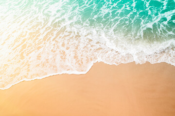 Top view of a wave on a beach. A wave rolling onto a sandy shore.