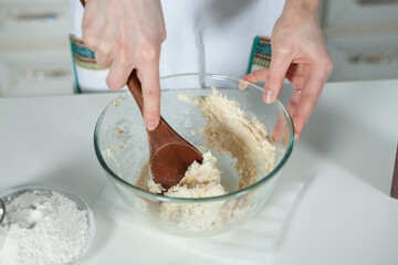hands of a woman preparing biscuits or cakes in the kitchen