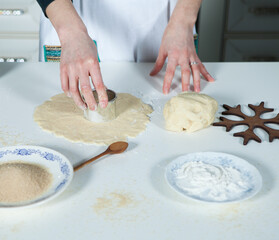 hands of a woman preparing biscuits or cakes in the kitchen