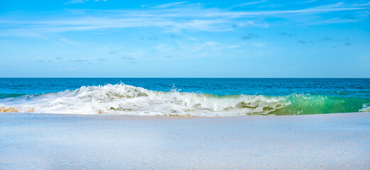 A beautiful blue ocean with a white foam line