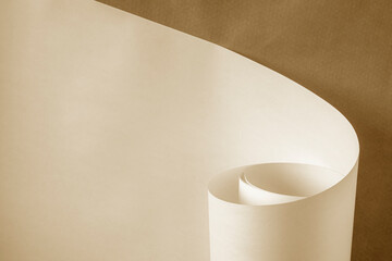 A sheet of warm colored rolled paper on a brown background.