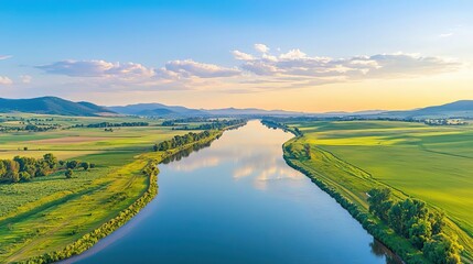 Aerial shot of river and tributary, reflecting surrounding farmland and hills, warm sunset hues, tranquil and vast