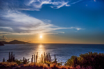 A beach with a small hill in the background