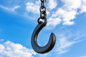 Obraz premium Crane chain and hook against blue sky