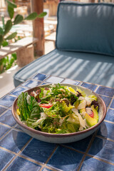 High angle shot of fresh vegetables salad with tomato and sauce