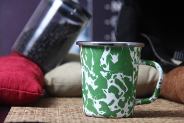 a cup of black coffee, and a jar of coffee beans ready to serve,