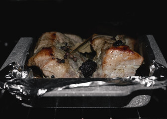 Baked meat cooking in oven