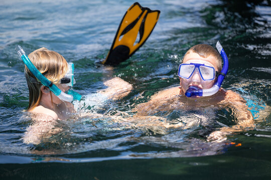 Kids snorkeling in river on summer holiday